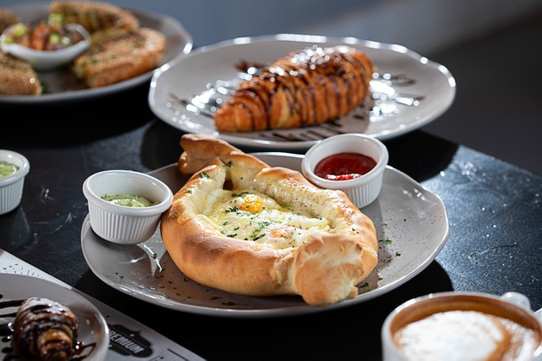 Khachapuri, center, a dish of cheese-filled bread, at Vaskers Bakery Cafe, 4235 S. Fort Apache Rd., Wednesday, Oct. 25, 2023.