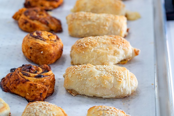 Pizza pastries, left, and pastries stuffed with Kashkaval cheese at Vaskers Bakery Cafe, 4235 S. Fort Apache Rd., Wednesday, Oct. 25, 2023.