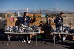 Volunteers pack squash at the Just One Project’s distribution center.