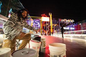 Local musician Mike Esquilin performs on a pedestrian bridge over Las Vegas Boulevard near Park MGM. 