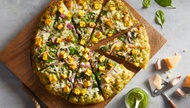 Tandoori chicken pizza comes with white garlic sauce, cheese, bell pepper, red onion, diced tomatoes, cilantro, and juicy, perfectly spiced chicken.