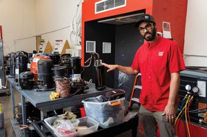 Kodi Wilson, campus director, shows an A/C compressor in the HVAC training lab at National Technical Institute in Henderson, Nevada.