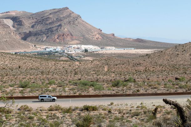 A vehicle heads eastbound on State Route 160 near the intersection of State Route 159 with the CertainTeed gypsum plant is in the background in 2021. A new housing development is slated for the area.