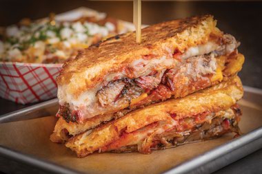 New game-day specials include bacon-wrapped jalapeños stuffed with brisket and cheddar cheese, beer-braised brats and the brisket grilled cheese sandwich.