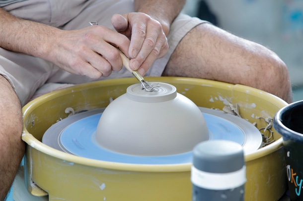 A man works at a potter’s wheel during independent studio time at Clay Arts Vegas.