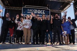 Representatives of local nonprofits and other community members take the stage during the announcement of the Space 2.0.