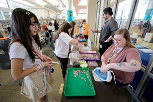 Aubrey Jacobs, a youth services assistant, irons a Perler beads design during a Teen Maker Fair at the Centennial Hills Library.