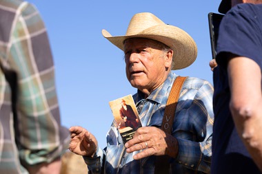 Cliven Bundy holds up a pocket U.S. constitution as he talks with reporters during a gathering on the Bundy Ranch in Bunkerville Saturday, April 5, 2025. The gathering was held to commemorate the Bundy standoff against the Bureau of Land Management in&nbsp;2014.