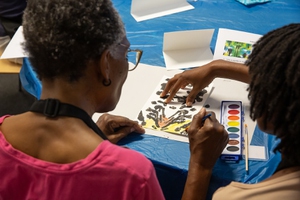 Participants and volunteers at the Cleveland Clinic Lou Ruvo Center work on a project during an art program that focuses on people living with dementia.