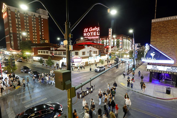 Pedestrians cross North Sixth Street at East Fremont Street in downtown Las Vegas Friday, Oct. 3, 2025.