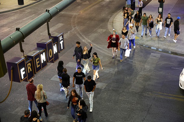 Pedestrians cross North Sixth Street at East Fremont Street in downtown Las Vegas Friday, Oct. 3, 2025.