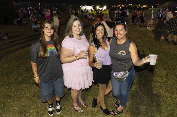 Attendees pose for a photo during the Las Vegas PRIDE festival at Desert Breeze Events Center, Saturday, Oct. 18, 2025.