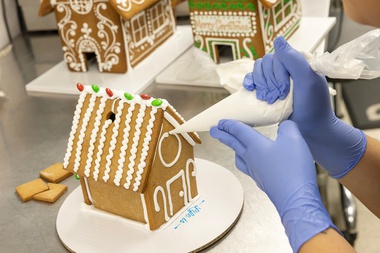 Mercedes Trujillo, lead cake decorator at Freed’s Bakery, assembles and decorates a gingerbread house&nbsp;kit. 