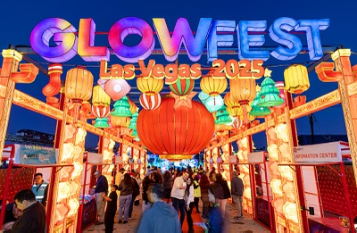 Guests head through the entrance into GlowFest, a holiday night market and light festival at Paradise Road and Sahara Avenue, Saturday, Dec. 20, 2025. The festival runs through Feb. 22.