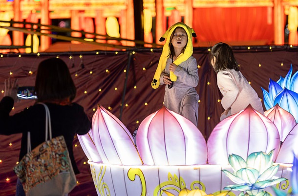 Childen play at a display during GlowFest, a holiday night market and light festival at Paradise Road and Sahara Avenue, Saturday, Dec. 20, 2025. The festival runs through Feb. 22.