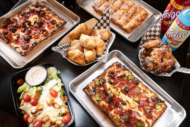 Detroit-style pizzas, Caesar salad, garlic parm wings, wild knots and hot churro bread at Guerrilla Pizza Company in Downtown Las Vegas.