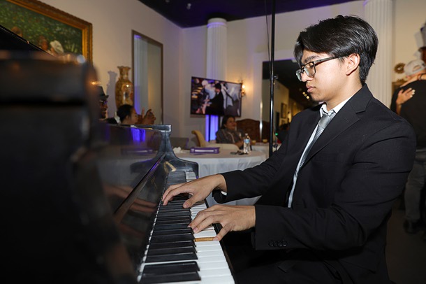 Christian Esquivel plays the piano during a soft opening of the Filipino American Museum in the Boulevard mall Saturday, Feb. 7, 2026.