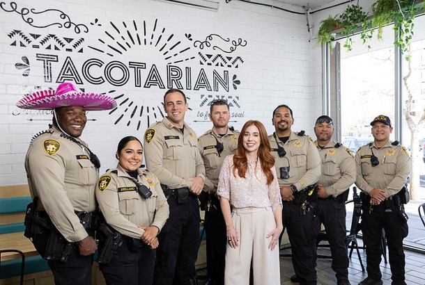 Kristen Corral, co-founder of Tacotarian, poses with Metro Police officers in the restaurant in the Arts District Tuesday, Feb. 24, 2026. From left: K. Flowers, E. Arellano, Capt. Adam Seeley, P. Zarate, L. Ramos. I Unaaite, and R. Ricafuenter. Corral and Seely worked together to change how downtown businesses report and address crime-related issues in their area.