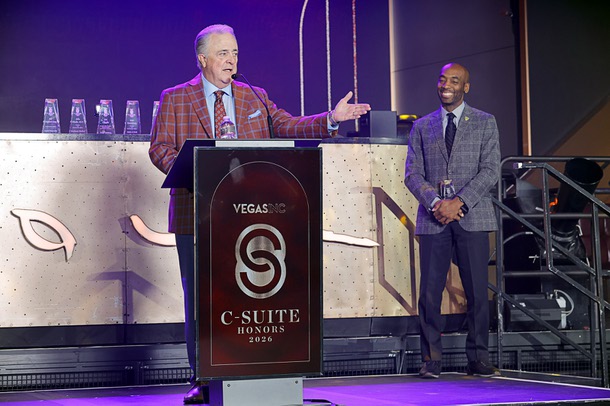 Honoree Don Logan, president/COO of the Las Vegas Aviators, speaks during the C-Suite Honors event in the Zouk Nightclub at Resorts World Wednesday, Feb. 25, 2026. Michael Crome, senior vice president and CFO for the Las Vegas Raiders, listens at right.