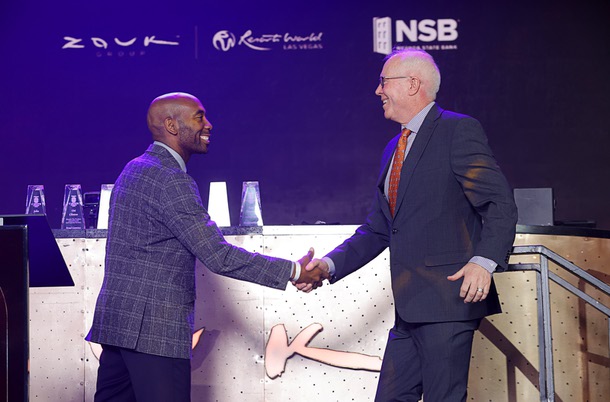Michael Crome, left, senior vice president and CFO for the Las Vegas Raiders, welcomes honoree John Rhodes, president/CEO Southwest Medical and Optum Nevada, onstage during the C-Suite Honors event in the Zouk Nightclub at Resorts World Wednesday, Feb. 25, 2026.