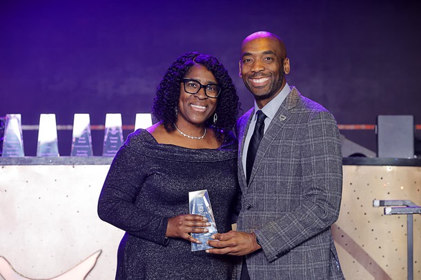 Sonja Roberts, left, who accepted the award for Uri Clinton, top, executive vice president, general consul and corporate secretary for Boyd Gaming, poses with Michael Crome, senior vice president and CFO for the Las Vegas Raiders, during the C-Suite Honors event in the Zouk Nightclub at Resorts World Wednesday, Feb. 25, 2026. Crome served as emcee for the event.