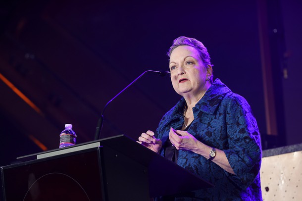 Caleen Norrod Johnson, accepts the award for honoree Karen Rubel, president of Chapters Health West and interim executive director for the Nathan Adelson Hospice Foundation, during the C-Suite Honors event in the Zouk Nightclub at Resorts World Wednesday, Feb. 25, 2026.