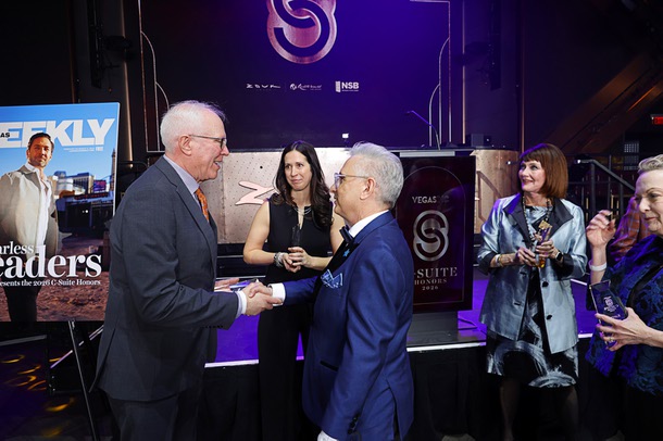 Honoree John Rhodes, left, president/CEO Southwest Medical and Optum Nevada, shakes hands with honoree Scott Rosenzweig, president/CEO of Make A Wish Nevada, as honoree Kim Virtuoso, chief people officer for Fontainebleau Las Vegas, looks on during the C-Suite Honors event in the Zouk Nightclub at Resorts World Wednesday, Feb. 25, 2026.