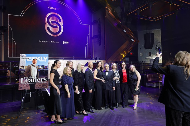 Honoree Kim Virtuoso, holding award, chief people officer for Fontainebleau Las Vegas, poses with her team during the C-Suite Honors event in the Zouk Nightclub at Resorts World Wednesday, Feb. 25, 2026.