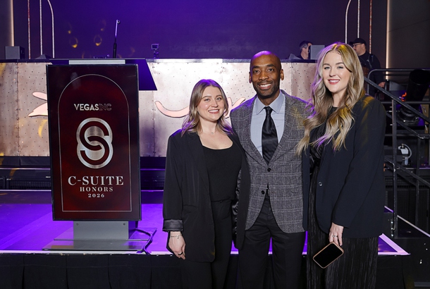 Hannah Anter, left, and Samantha Lamb, right, of the Greenspun Media Group pose with Michael Crome, senior vice president and CFO for the Las Vegas Raiders, during the C-Suite Honors event in the Zouk Nightclub at Resorts World Wednesday, Feb. 25, 2026.