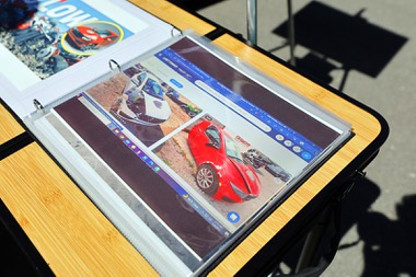 Photos of three-wheeled Solo electric cars in a junkyard are displayed during an Electric Vegas Recycle & Ride event at Allegiant Stadium Saturday, April 4, 2026. Owner Andrew Phillips bought the two cars to make one working model, he&nbsp;said.