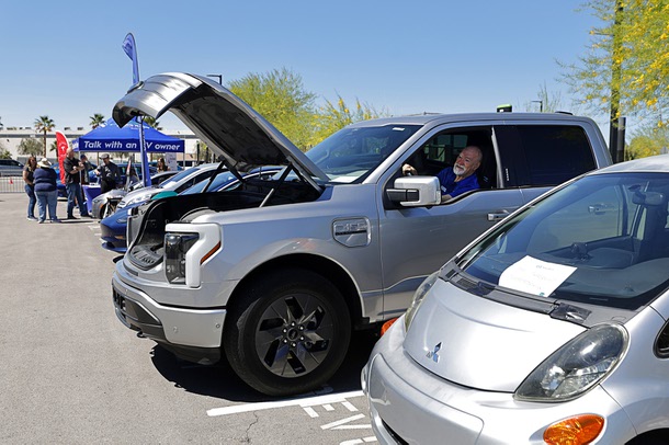 Owner Ed Malkiewicz remotely opens and closes the “frunk,” (front trunk) of his 2022 Ford Lightning Lariat electric pickup truck during an Electric Vegas Recycle & Ride event at Allegiant Stadium Saturday, April 4, 2026. Local electric vehicle enthusiasts, auto dealerships, and environmental organizations participated in the event.