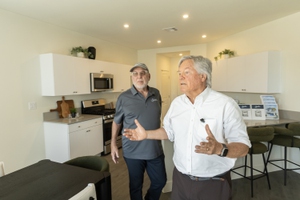 Signature Homes CEO Richard Plaster (left) and Clark County Commissioner Tick Segerblom tour a model home at Paradise Trails on March 25.