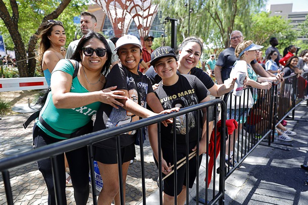 Fans pose on the parade route on Bruno Mars Drive Friday, April 10, 2026, during “Bruno Mars Day” in Las Vegas.
