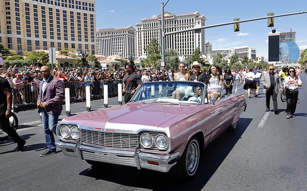 Entertainer Bruno Mars, center, rides in a parade on the Las Vegas Strip Friday, April 10, 2026, in Las Vegas. Nevada governor Joe Lombardo proclaimed April 10, 2026 as “Bruno Mars Day” and Clark County renamed a street to Bruno Mars Drive in his honor.