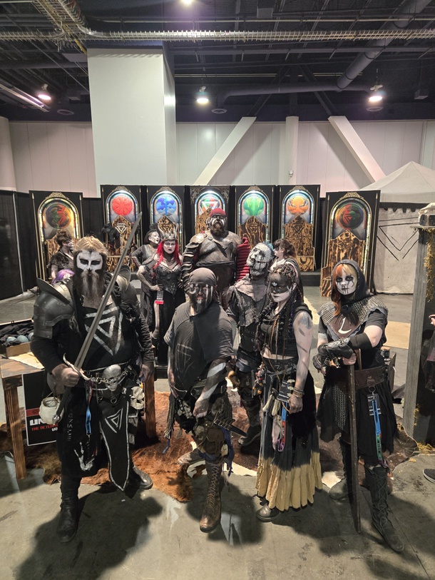 The Wild Guild, a troup of fantasy and medieval event performers, takes a break from taking entries for their giveaways to pose in full regalia. (https://www.instagram.com/thewildguild/)  