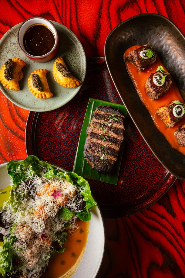 Maroon patties, crispy Chilean sea bass, rum-aged steak and piri piri chop salad