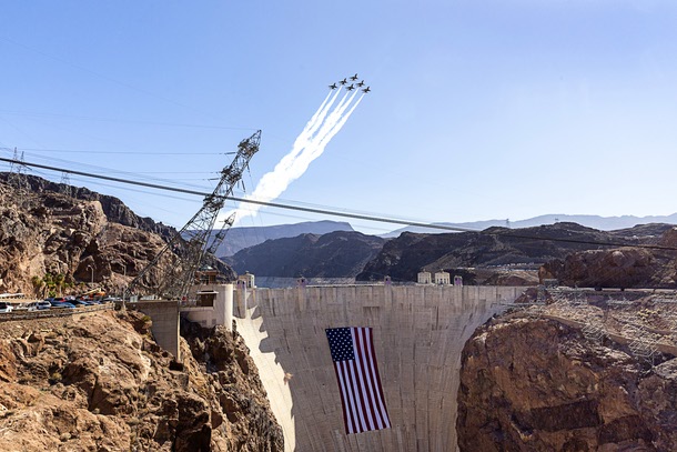 The United States Air Force Thunderbirds, the official aerial demonstration team of the U.S. Air Force, perform a flyover above Hoover Dam, adorned with a 300-foot-wide by 150-foot-tall American flag, Tuesday, June 30, 2026. The Thunderbirds will travel to Washington, D.C., for the Salute to America250 celebration.