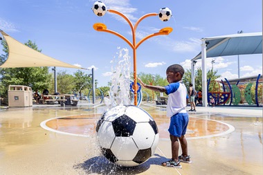 Ace Munongo, 3, keeps cool at a splash pad at Baker Park, 1020 E. St. Louis Ave.,Saturday, July 25, 2026.